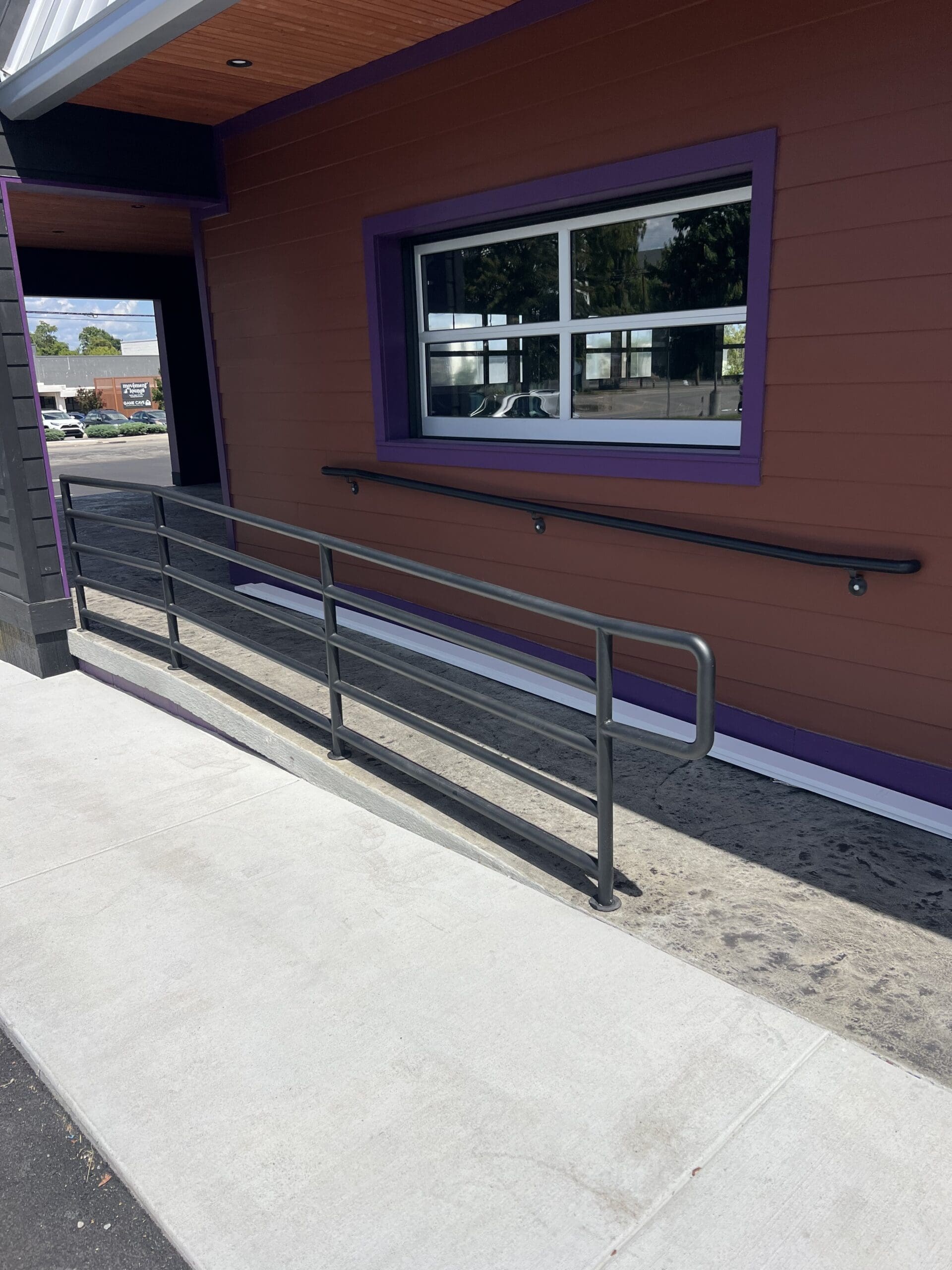 Powder-coated steel commercial handrail installed at Red Door restaurant in Donelson, Tennessee by Accurate Fabrication.